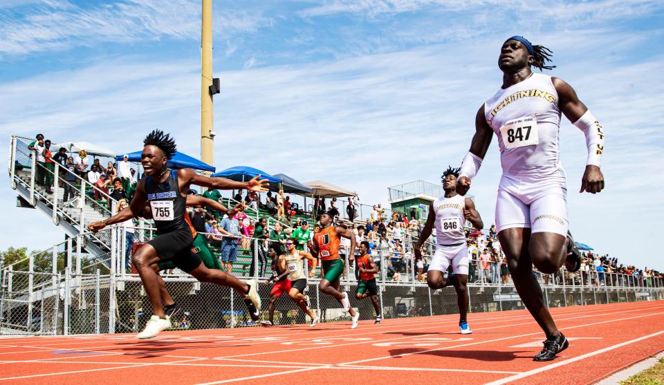 Dandre Morrison, left, of Ida Baker and LehighÕs Richard Young, right,  sprint to the line during the 100 meters at Lee County Athletic Conference Championships at Dunbar High School on Saturday, April 9, 2022. Morrison won and Young was second.  