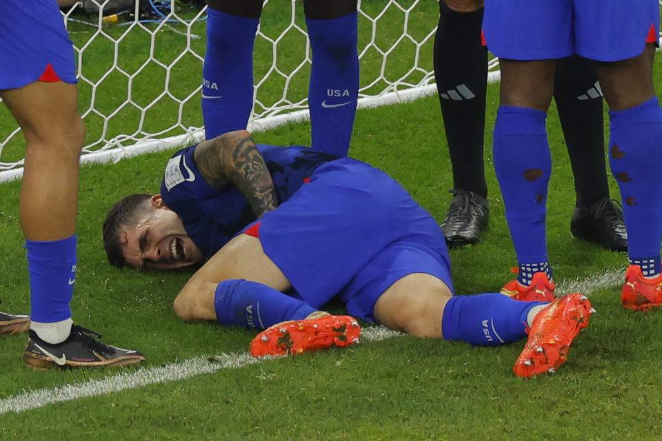 Christian Pulisic reacts following a collision during the Qatar 2022 World Cup Group B football match between Iran and USA