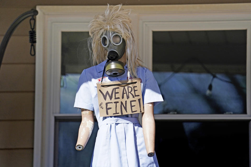 A resident displays a mannequin on their porch in East Palestine, Ohio, as cleanup from the Feb. 3 Norfolk Southern train derailment continues, Friday, Feb. 24, 2023. (AP Photo/Matt Freed)