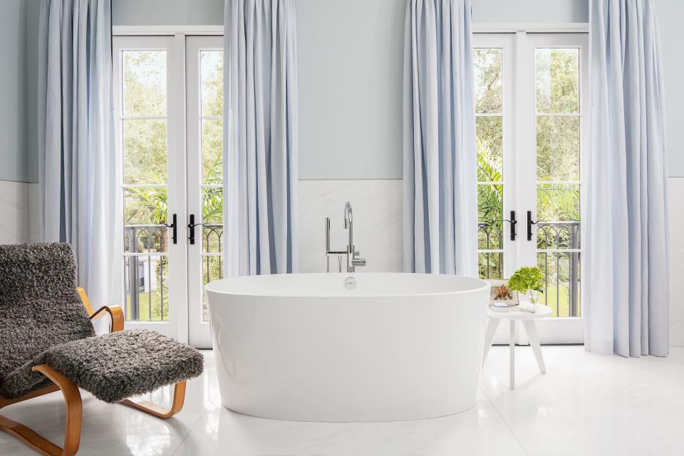 The light-filled master bath is painted in Benjamin Moore’s blue lace.