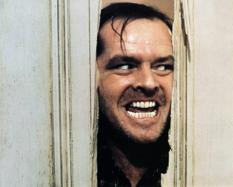 Jack Nicholson sticking his head through a splintered door with a sinister smile