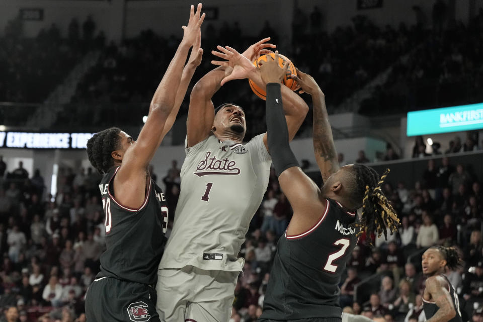 Mississippi State forward Tolu Smith (1) is stripped of the ball by South Carolina forwards B.J. Mack (2) and Collin Murray-Boyles (30) during the second half of an NCAA college basketball game, Saturday, March 9, 2024, in Starkville, Miss. South Carolina won in overtime 93-89. (AP Photo/Rogelio V. Solis)