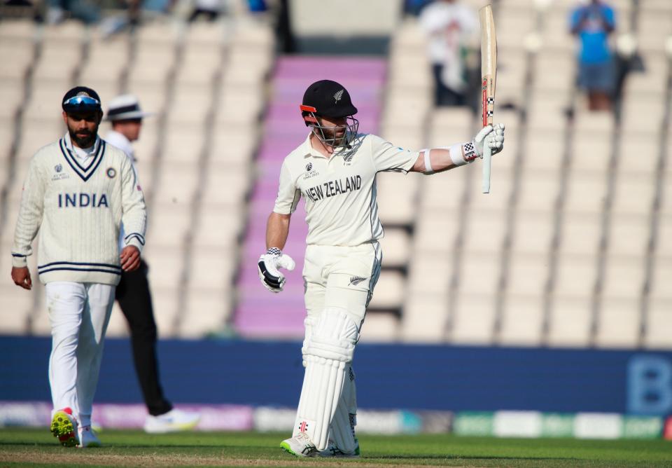 New Zealand’s captain Kane Williamson raises his bat to celebrate scoring fifty runs during the sixth day of the World Test Championship final cricket match between New Zealand and India.