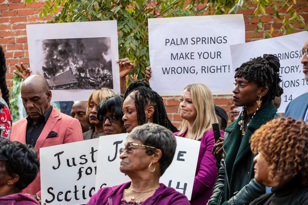 People who lived on Section 14, or whose relatives did, gather along with elected officials during a press conference Tuesday in Los Angeles.