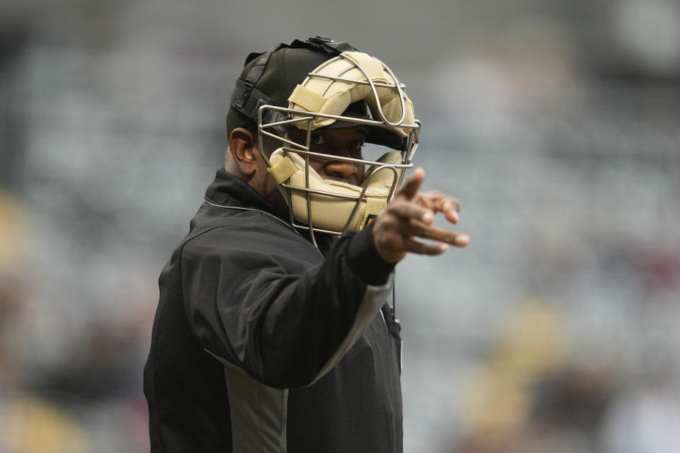 An umpire signals for a strike after being told a strike call through an earpiece during the first inning of a minor league baseball game between the St. Paul Saints and the Nashville Sounds, Friday, May 5, 2023, in St. Paul, Minn. Automatic balls and strikes could soon be coming to the major leagues. Much like the players themselves, robo-umps are working their way up through the minors with the goal being promoted to the show. (AP Photo/Abbie Parr)