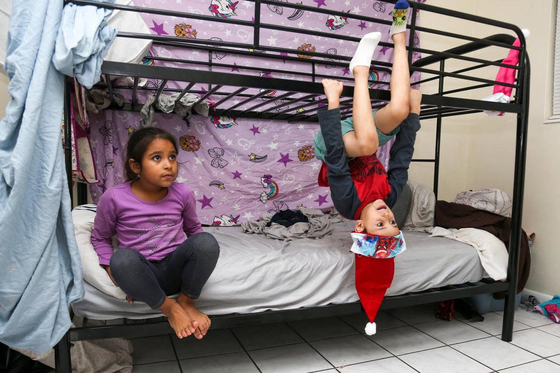 Janthony Santana, 6, and the youngest of his siblings, hangs out with his sister Janabella, 7, while they  watch TV.