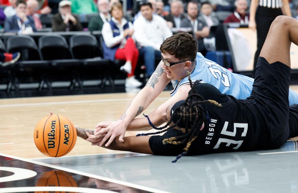 Missouri State sophomore N.J. Benson (35) and Indiana State sophomore Robbie Avila (21) reach for a loose ball during a Missouri Valley Conference Tournament game between Missouri State and Indiana State, Friday, March 8, 2024, at Enterprise Center in St. Louis.