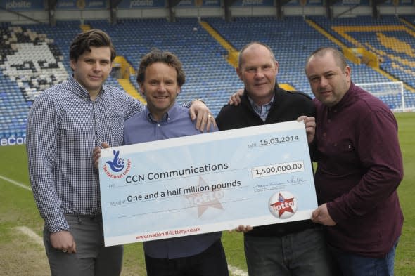 Handout photo issued by Camelot of the CCN Communications syndicate members (left to right)  Lewis Fox, Tom Fox,  Mark Bush and Sid Veness cas they celebrate their jackpot win at Fratton Park, Portsmouth of ?1,558,848, one of four lucky ticket holders from the Lotto draw last Saturday.  PRESS ASSOCIATION Photo. Picture date: Wednesday March 19, 2014. See PA story LOTTERY Engineers. Photo credit should read: Ady Kerry/Camelot                    /PA WireNOTE TO EDITORS: This handout photo may only be used in for editorial reporting purposes for the contemporaneous illustration of events, things or the people in the image or facts mentioned in the caption. Reuse of the picture may require further permission from the copyright holder.