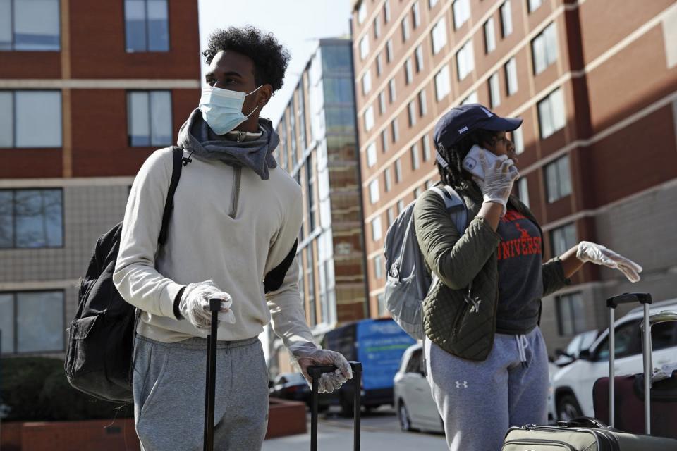 <span class="caption">A Howard University student from Trinidad and Tobago wears a face mask and plastic gloves as he moves out of his dorm room in Washington, D.C. on March 18.</span> <span class="attribution"><a class="link " href="http://www.apimages.com/metadata/Index/Virus-Outbreak-Washington-Daily-Life/91b2604378954143afc91b4eab6436cc/6/0" rel="nofollow noopener" target="_blank" data-ylk="slk:AP Photo/Patrick Semansky;elm:context_link;itc:0;sec:content-canvas">AP Photo/Patrick Semansky</a></span>