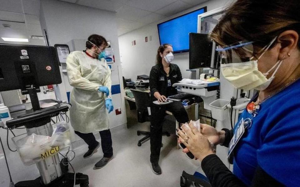 Nurse Alix Zacharski, right, sanitizes her hands in the Medical Intensive Care Unit for COVID-19 patients at Jackson Memorial Hospital in July 2021. Jackson Health ranked nationally in rehab for adults and pediatric diabetes and endocrinology.