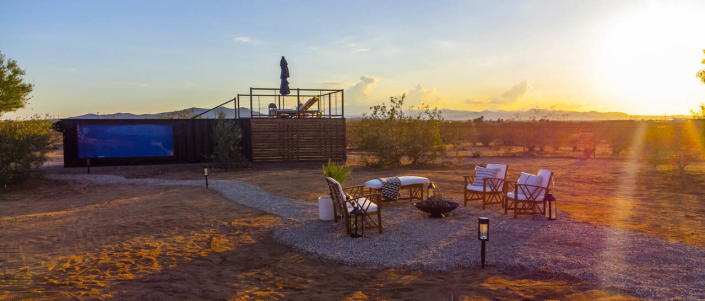 Cozy outdoor seating area around a small fire pit by the ModPools shipping container pool in Joshua Tree.