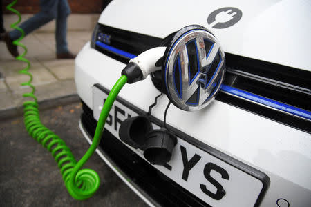 FILE PHOTO: An electric Volkswagen car is plugged into a recharging point in central London, Britain November 10, 2016. REUTERS/Toby Melville/File Photo