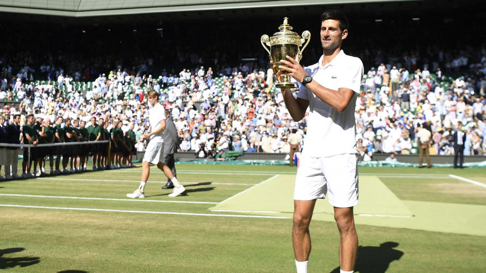 Serbia’s Novak Djokovic holds the winners trophy after beating South Africa’s Kevin Anderson 6-2, 6-2, 7-6 in their men’s singles final match on the thirteenth day of the 2018 Wimbledon Championships at The All England Lawn Tennis Club in Wimbledon, southwest London, on July 15, 2018. (Photo by NEIL HALL / AFP) / RESTRICTED TO EDITORIAL USE (Photo credit should read NEIL HALL/AFP/Getty Images)