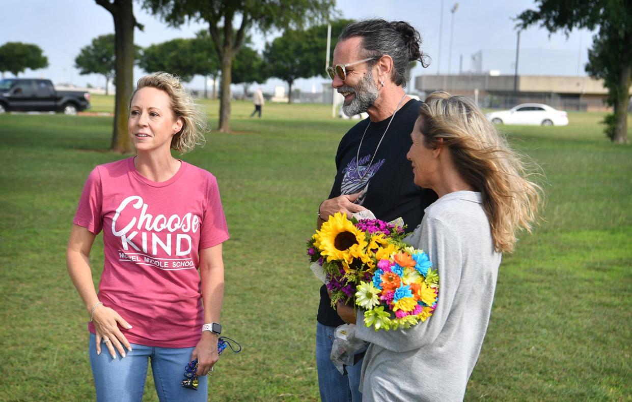 McNiel Middle School principal Summer Bynum talks with Vern and Bianka Landavazo as a new memorial horse is installed at the school as shown in this May 27, 2021, file photo. The Landavazos are parents of Lauren Landavazo who was slain on her way home from school September 2, 2016. The previous horse was stolen.