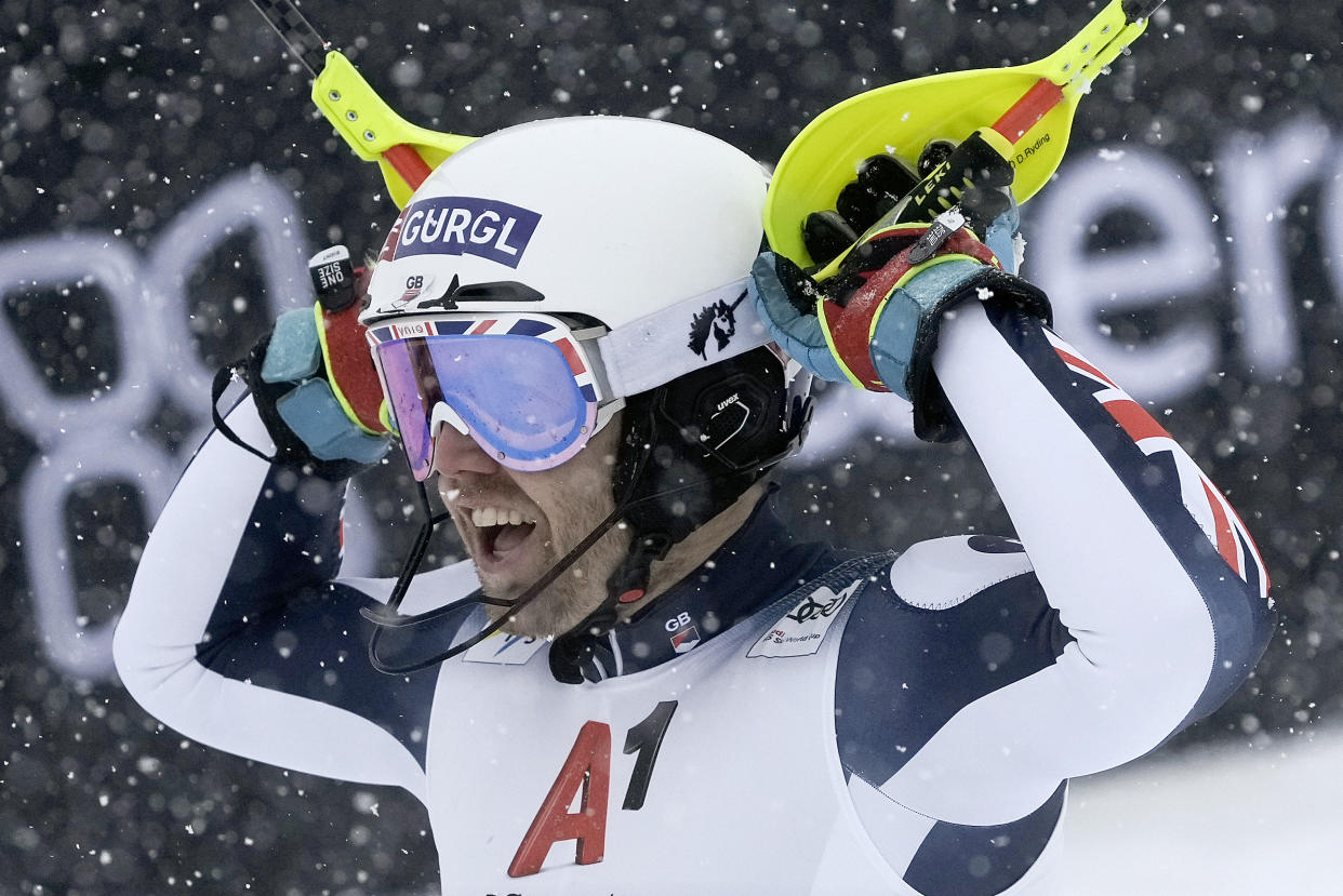 FILE - Britain's Dave Ryding celebrates at the finish area of an alpine ski, men's World Cup slalom, in Kitzbuehel, Austria, Saturday, Jan. 22, 2022. When David Ryding gets to the start gate of the men's slalom at the Beijing Games on Wednesday, he knows expectations of a British skier will be high for once. Ryding became the first British winner in the 55-year history of the Alpine skiing World Cup, and on one of the circuit's most challenging slalom courses, when he triumphed in Kitzbühel last month. Now the 35-year-old is bidding to end his country's lengthy wait for a first Olympic medal in Alpine skiing. (AP Photo/Giovanni Auletta, File)