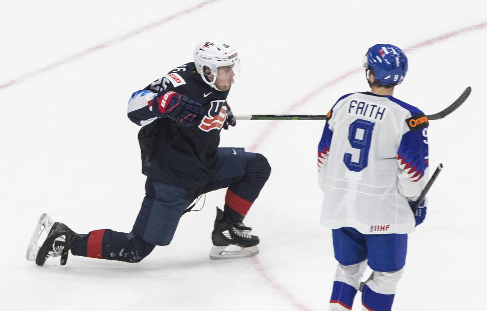 United States' John Farinacci (25) celebrates his goal as Slovakia's Roman Faith (9) looks on during the third period of an IIHL World Junior Hockey Championship game, Saturday, Jan. 2, 2021 in Edmonton, Alberta. (Jason Franson/The Canadian Press via AP)