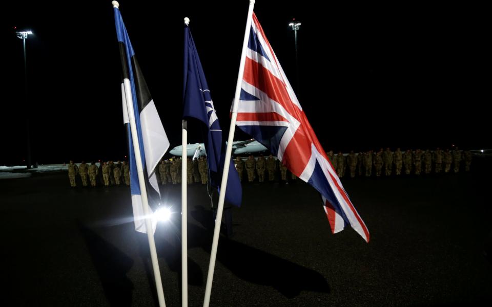 The flags Estonia, NATO and Britain at the arrival ceremony  - Credit: INTS KALNINS /Reuters