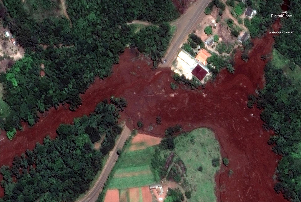 This Jan. 29, 2019 satellite image provided by DigitalGlobe shows mud flooding an area days after a Jan. 25 mining company's dam collapsed, near Brumadinho, Brazil. As search-and-recovery efforts continued, authorities also worked to slow the reddish-brown mud that was heading down a small river with high concentrations of iron oxide, threatening to contaminate a much larger waterway that provides drinking water to communities in five of the country’s 26 states. (DigitalGlobe, a Maxar company via AP)