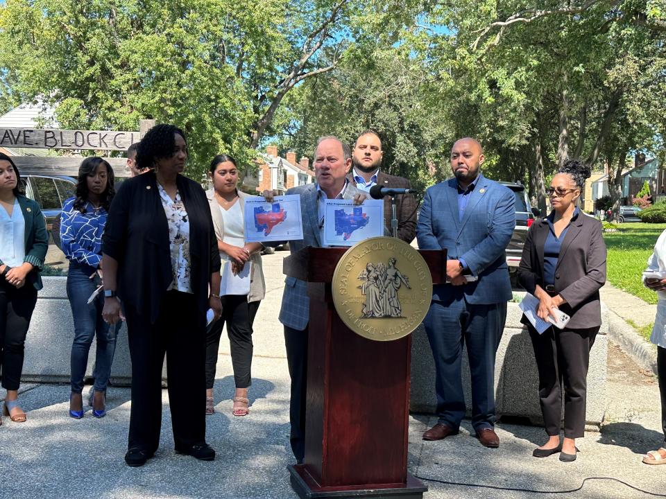 Mayor Mike Duggan presents a proposed look of how Detroit's tax rates would compare to nearby cities, if voters approve a tax plan that would cut homeowners' property taxes and increase vacant land taxes, on Aug. 31, 2023.