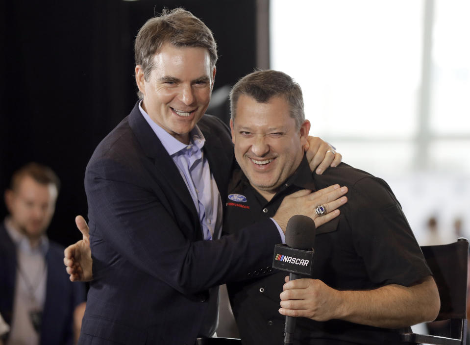 Tony Stewart, right, is congratulated by Jeff Gordon after being named to the NASCAR Hall of Fame class of 2020 during an announcement in Charlotte, N.C., Wednesday, May 22, 2019. (AP Photo/Chuck Burton)