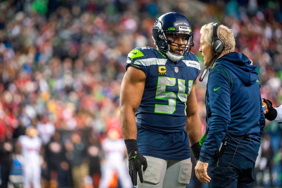 Seattle Seahawks middle linebacker Bobby Wagner (54) talks with head coach Pete Carroll during a timeout just before the San Francisco 49ers fourth-and-goal play during the fourth quarter of an NFL game on Sunday at Lumen Field in Seattle.