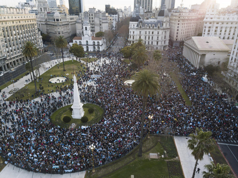 Supporters of Argentina President Mauricio Macri stand at Plaza de Mayo in Buenos Aires, Argentina, Saturday, Aug. 24, 2019. Following a social media campaign large numbers of people gathered in the center of Buenos Aires on Saturday to show their support for the government of Maurico Macri. (AP Photo/Tomas. F Cuesta)