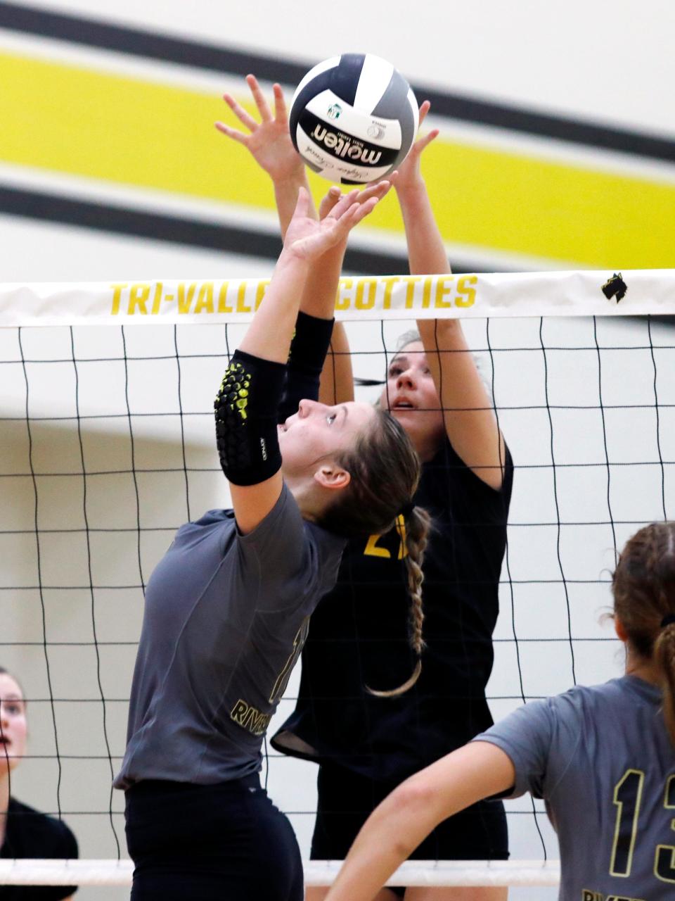 Kayla Dulgar sets up a kill while Sami Cameron goes up for a block during River View's 25-23. 25-13, 15-25, 29-27, 15-12 win against host Tri-Valley on Tuesday night in Dresden.