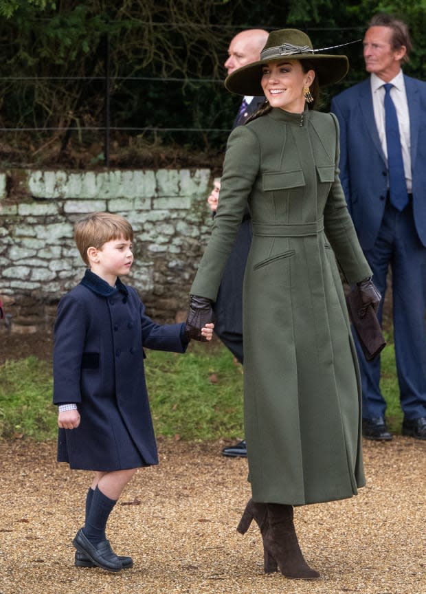 <p>Prince Louis joins Kate Middleton at Christmas at Sandringham in 2022. Middleton sports more muted tones than she usually does for the festive occasion, wearing a deep olive green Alexander McQueen coat and brown suede boots.</p><p>Samir Hussein/WireImage</p>