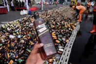 <p>Thousands of alcoholic beverages from unlicensed sellers are destroyed at Polda Metro Jaya, May 23, 2017. Indonesian police conduct the destruction of alcoholic beverages ahead of Ramadhan and Idul Fitri celebrations anticipate the high number of crime caused by alcohol. (Photo: Dasril Roszandi/NurPhoto via Getty Images) </p>