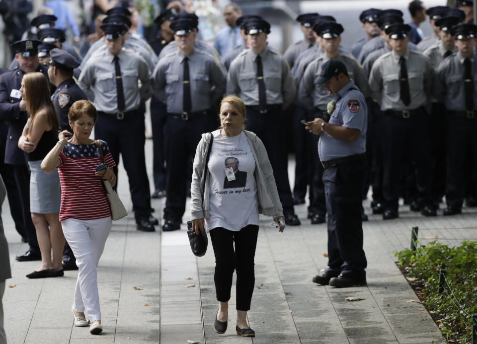 People gather for a ceremony marking the 18th anniversary of the attacks of Sept. 11, 2001 at the National September 11 Memorial, Wednesday, Sept. 11, 2019 in New York. (AP Photo/Mark Lennihan)