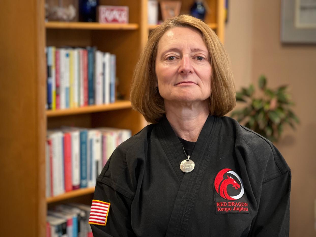 Christine DiBlasio used her 30 years as clinical psychologist focused on trauma recovery and martial arts training as a fifth degree blackbelt in Kenpo Jiujitsu to create a free program for sexual assault survivors that incorporates the mind and body to promote healing. She has been named USA TODAY's Women of the Year honoree from Vermont. DiBlasio is pictured in her South Burlington office wearing her karate gi on December 14, 2022.