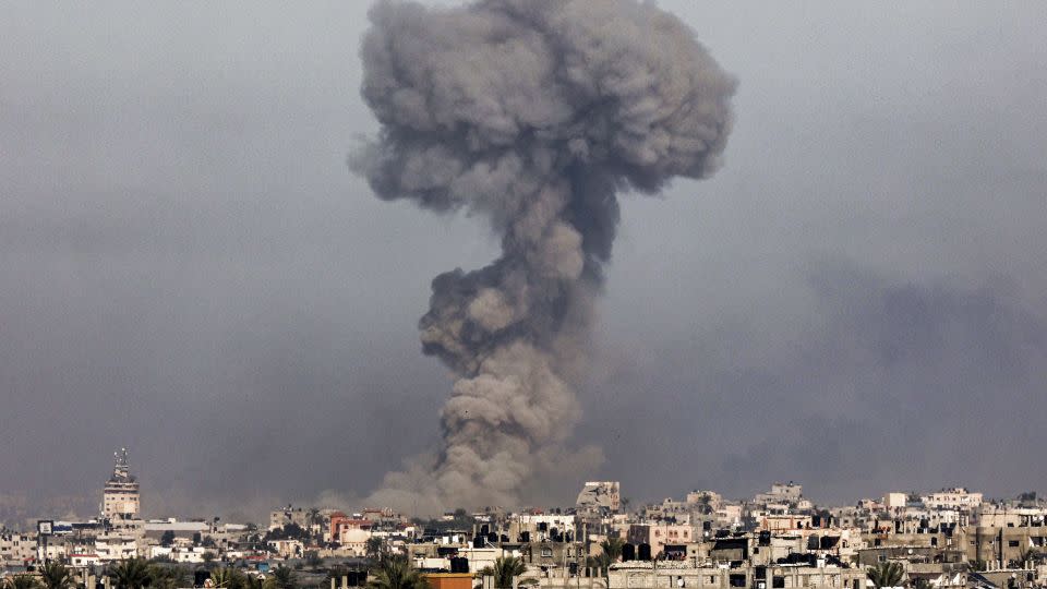 A smoke plume erupts over Khan Younis from Rafah in the southern Gaza strip during Israeli bombardment on January 8. - AFP/Getty Images