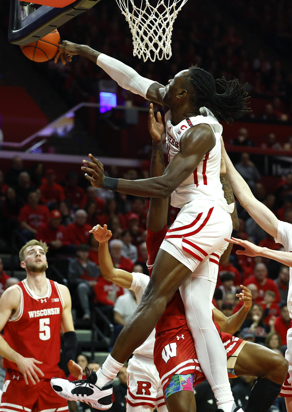 Rutgers center Clifford Omoruyi (11) blocks the shot of Wisconsin guard AJ Storr (2) during the first half of an NCAA college basketball game, Saturday, Feb. 10, 2024, in Piscataway, N.J. (AP Photo/Noah K. Murray)