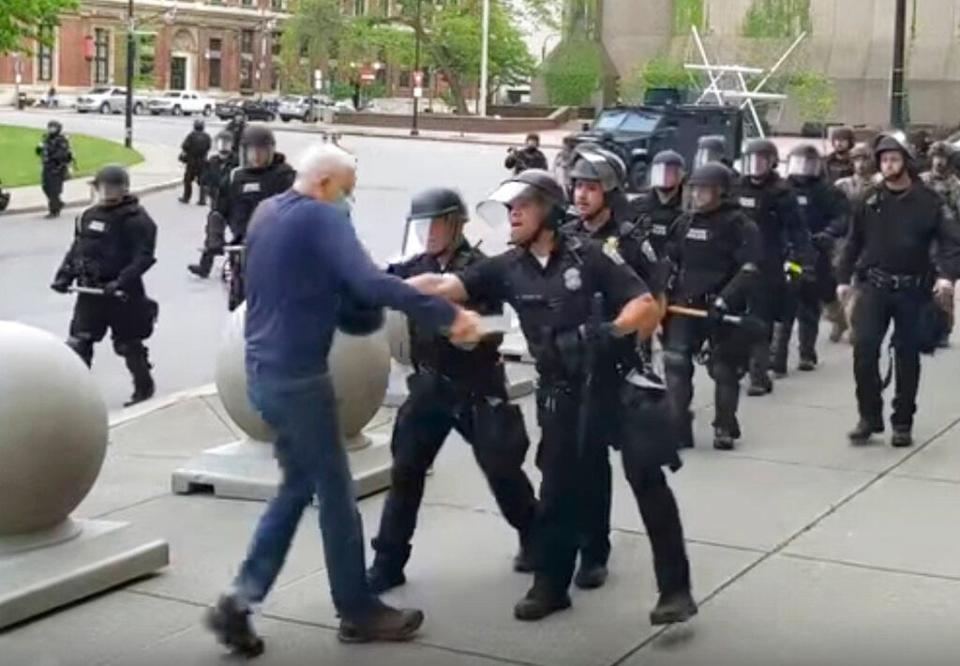 In this image from video by WBFO, a Buffalo police officer appears to shove a man who walked up to police Thursday, June 4, 2020, in Buffalo, N.Y.