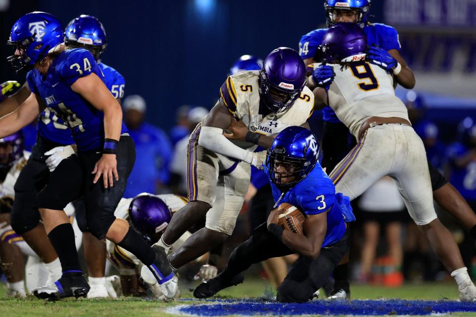 Trinity Christian Academy's Treyaun Webb (3) is tackled by Columbia's Jaden Robinson (5) during the fourth quarter of a regular season football game Friday, Sept. 23, 2022 at Trinity Christian Academy in Jacksonville. Trinity Christian Academy defeated the Columbia Tigers 43-30.  