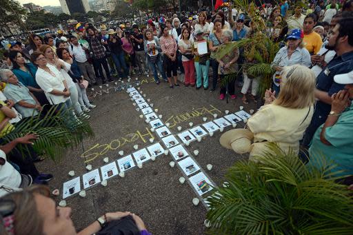 Manifestación en Caracas, el 18 de marzo de 2014, con las fotos de personas fallecidas en más de un mes de protestas contra el gobierno de Nicolás Maduro (AFP | Juan Barreto)