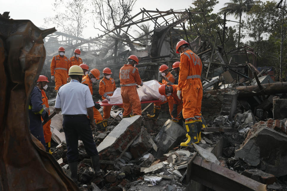 National Disaster Response Force rescuers carry the dead body of a person after an explosion and fire at a chemical factory in Dombivali near Mumbai, India, Friday, May 24, 2024. Multiple people were killed and dozens were injured in the incident that happened Thursday. (AP Photo/Rajanish Kakade)