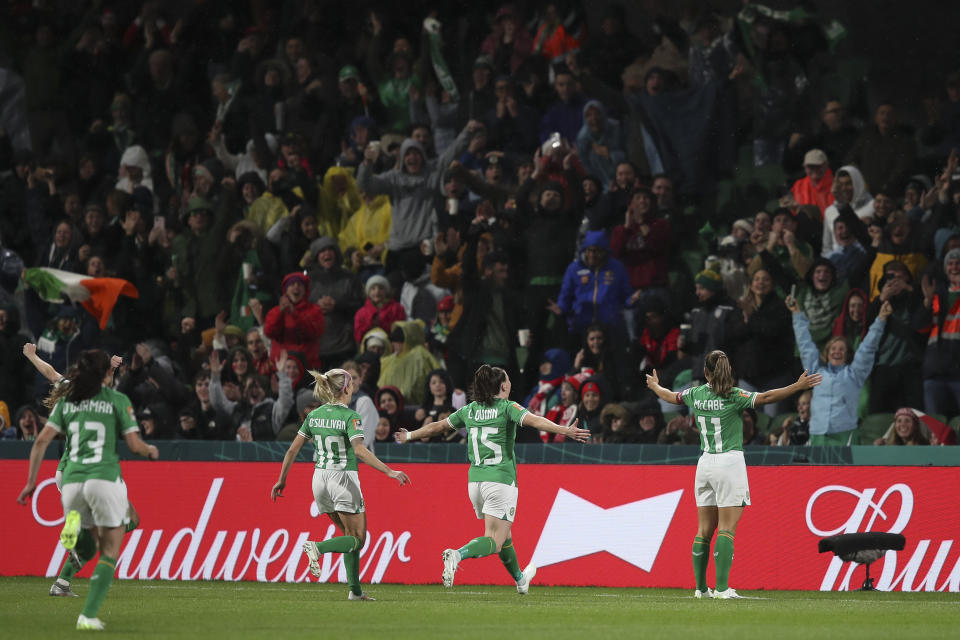 Ireland's Katie McCabe, right, celebrates after scoring the opening goal from a corner during the Women's World Cup Group B soccer match between Canada and Ireland in Perth, Australia, Wednesday, July 26, 2023. (AP Photo/Gary Day)