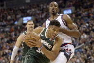 Milwaukee Bucks forward Giannis Antetokounmpo (34) drives past Toronto Raptors center Serge Ibaka (9) during the first half of an NBA basketball game Tuesday, Feb. 25, 2020, in Toronto. (Nathan Denette/The Canadian Press via AP)