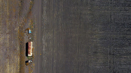 An old bus used for storing farming equipment stands in a drought-effected paddock on a property located west of the town of Gunnedah in New South Wales, Australia, June 3, 2018. REUTERS/David Gray