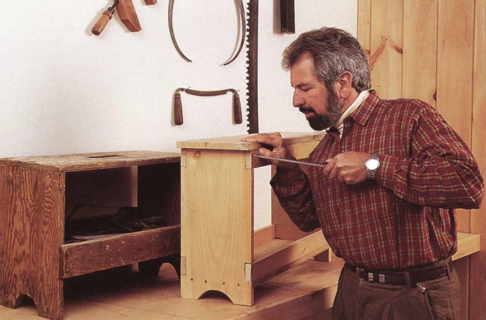 Bob Vila working on furniture in his workshop.