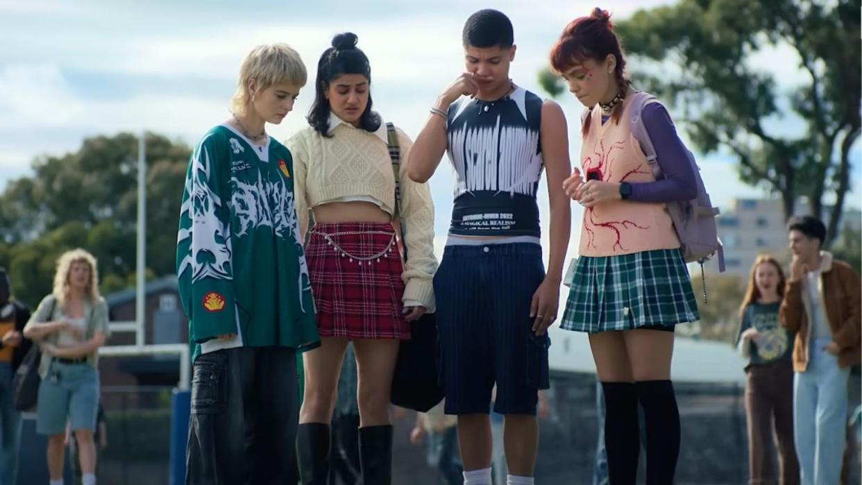  Harper, Amerie, Darren, and Quinni looking down in disgust at a dead bird in a backpack in Heartbreak High. 