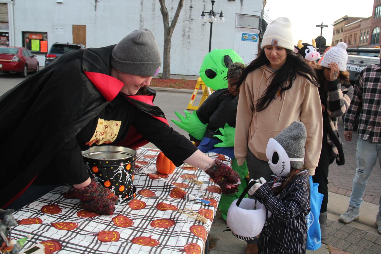 Andrea Brownlee hands out treats at the First Christian Church table during the 2023. Spooktacular Downtown Trick-or-Treat Walk. Brownlee is one of the finalists for the Jack Finneseth Memorial Volunteer of the Year Award.
