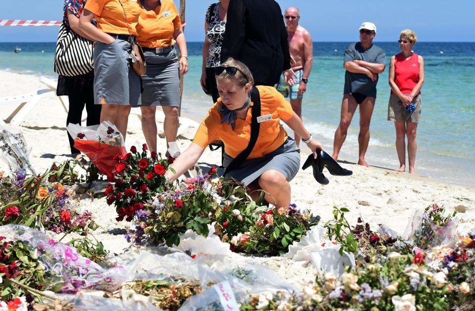 Tourists lay flowers in memory of those killed by a jihadist gunman on the beach in front of the Riu Imperial Marhaba Hotel in Tunisia: Getty