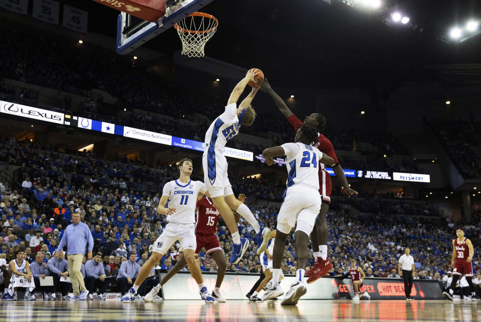 Nebraska's Juwan Gary, right, reaches for a rebound against Creighton's Ryan Kalkbrenner, from left, Baylor Scheierman and Arthur Kaluma during the first half of an NCAA college basketball game on Sunday, Dec. 4, 2022, in Omaha, Neb. (AP Photo/Rebecca S. Gratz)