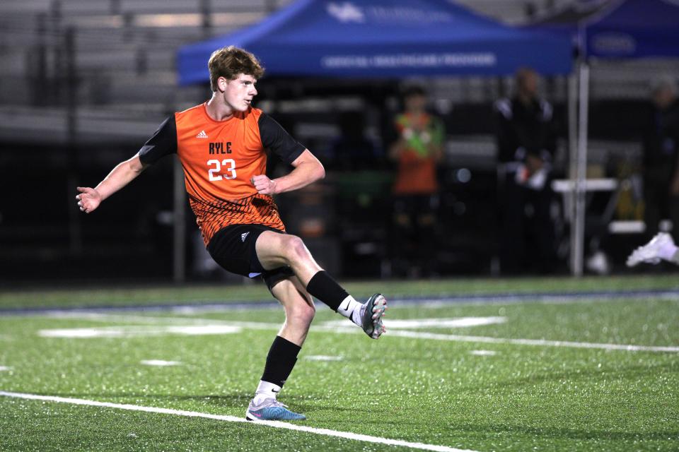 Ryle senior Josh Line passes the ball ahead as Ryle and St. Xavier faced off in the KHSAA boys soccer state semifinals Oct. 25, 2023 at Lafayette High School, Lexington, Ky.