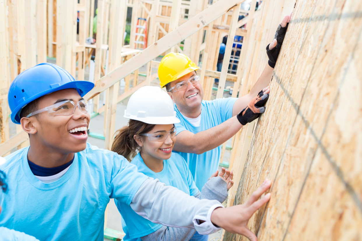 Employees building houses for charity work