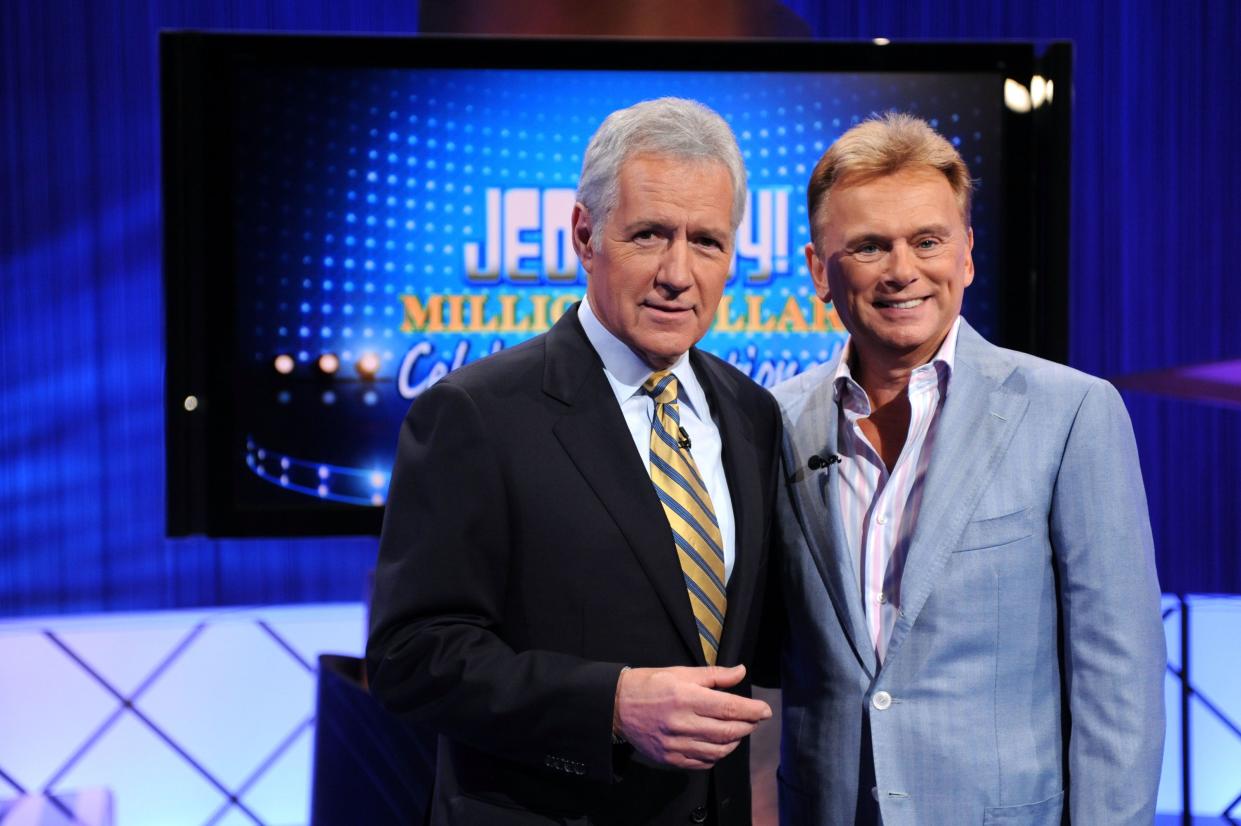 Game show hosts Alex Trebek (L) and Pat Sajak (R) pose on the set of the "Jeopardy! Million Dollar Celebrity Invitational Tournament Show" taping on April 17, 2010, in Culver City, Calif.