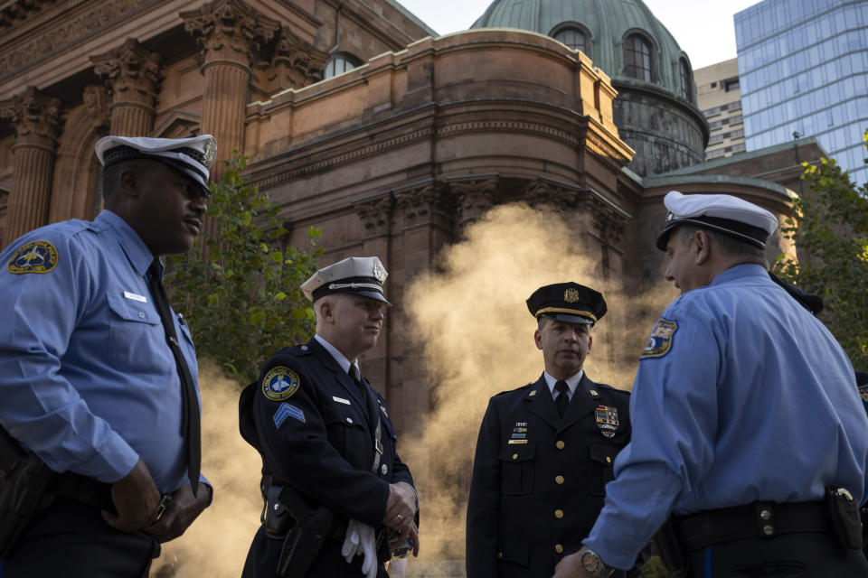 Law enforcement officers gather for a service for officer Richard Mendez at the Cathedral Basilica of Saints Peter and Paul in Philadelphia, Tuesday, Oct. 24, 2023. Mendez was shot and killed, and a second officer was wounded when they confronted people breaking into a car at Philadelphia International Airport, on Oct. 12, police said. (AP Photo/Joe Lamberti)