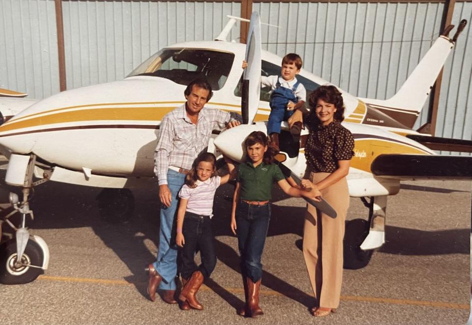 Douglas Happ, his wife and three young children pose in front of the family's Cessna.